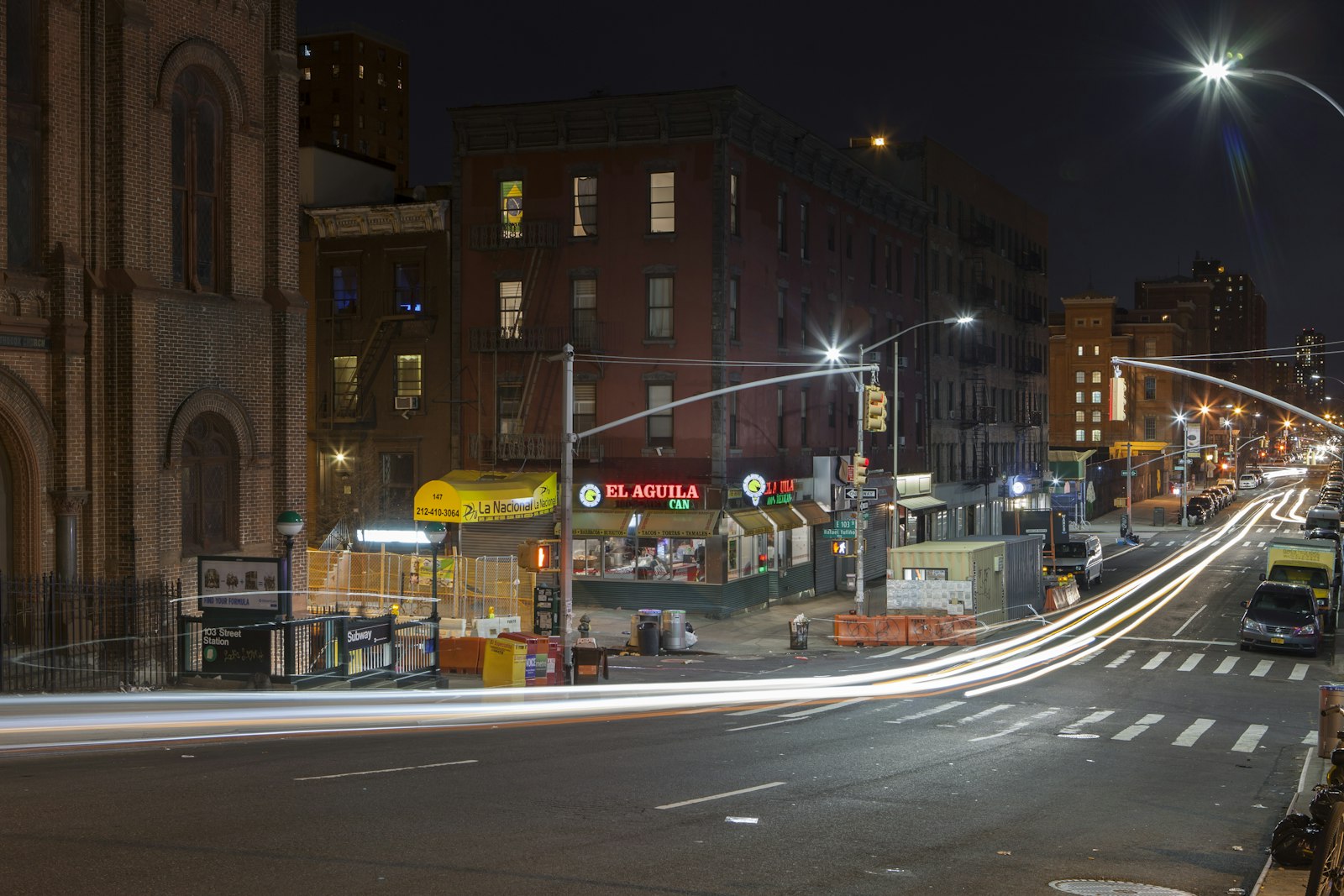 Neighborhood street corner in Spanish Harlem, New York City, at night